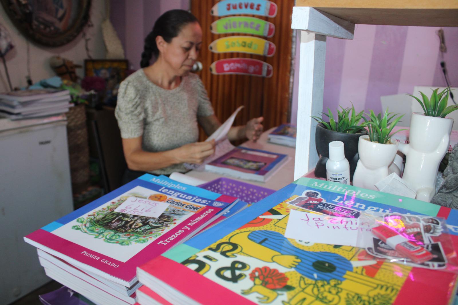 $!Lucía, con paciencia, en el regreso a clases hace del forrado de libros un oficio