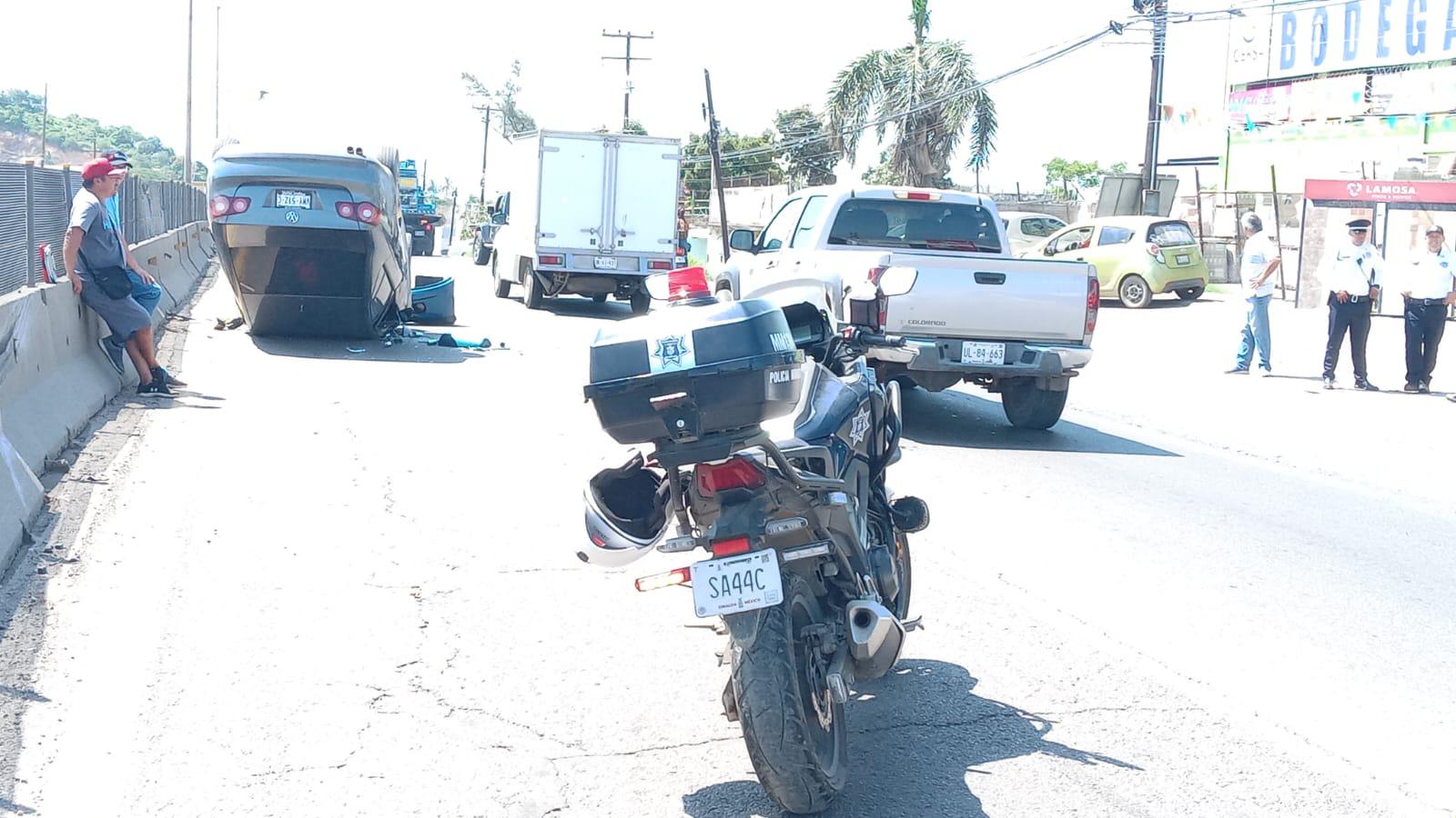 $!Auto vuelca tras chocar contra muro y tráiler que maniobraba en el sur de Mazatlán