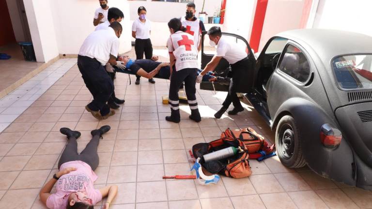 En el patio frente a la Escuela de la Cruz Roja Mexicana en este puerto las y los estudiantes realizaron una práctica de atención a dos personas heridas en un accidente vehicular.