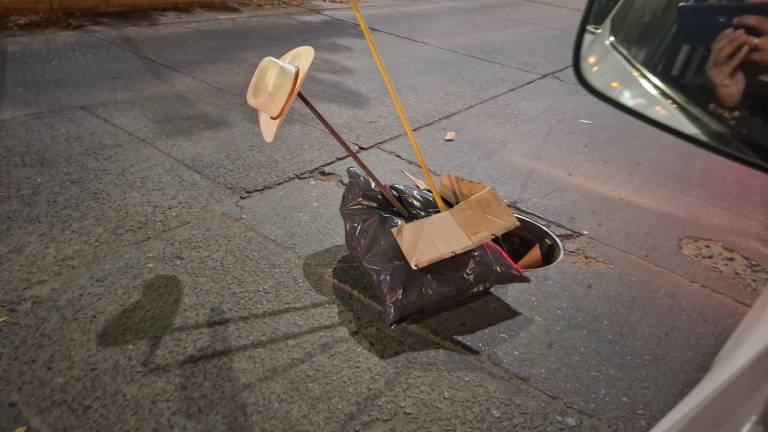 Una bolsa negra con una varilla y un sombrero puesta al lado de una alcantarilla alertó a las autoridades.