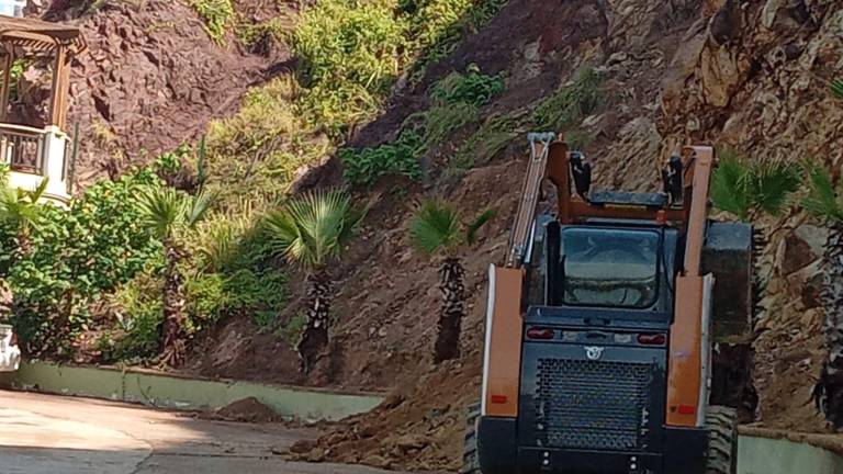 Personal de Servicios Públicos Municipales retira la tierra y piedras que cayeron sobre el Paseo del Centenario.