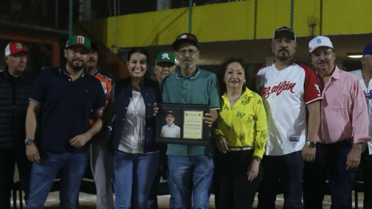 Diego Raygoza recibe su placa de reconocimiento.